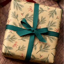 Load image into Gallery viewer, Three wrapped gift boxes arranged on a rustic wooden surface. One box is wrapped in olive green paper with red-and-white twine, while the other two are wrapped in tan kraft paper with a green pine branch pattern and tied with dark green ribbon bows.