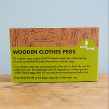 Load image into Gallery viewer, Box of wooden clothes pegs on a wooden surface with a light blue background
