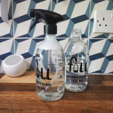 Load image into Gallery viewer, Two clear glass spray bottles with black triggers and printed black text reading 'fall everything clean' on a wooden countertop, with a blue-and-white geometric tiled backsplash behind them.