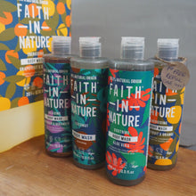 Load image into Gallery viewer, Multiple bottles of 'Faith In Nature' on a wooden surface with colorful packaging.
