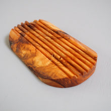 Load image into Gallery viewer, Wooden comb with a textured handle on a light gray background