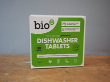 Load image into Gallery viewer, A box of bioD Dishwasher Tablets standing upright on a wooden surface against a plain gray wall.