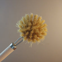 Load image into Gallery viewer, A close-up of a natural bristle duster with a light wood handle and metal ferrule, shown against a soft beige background.