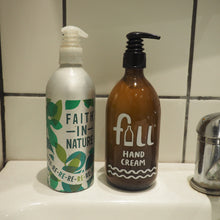 Load image into Gallery viewer, Two hand wash products on a white sink counter in front of a tiled wall: a white bottle labeled 'FAITH IN NATURE' with green leaf graphics, and an amber bottle labeled 'full hand cream' with a black pump.
