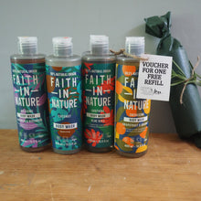 Load image into Gallery viewer, Four bottles of 'Faith in Nature' products on a wooden surface with a gray background.
