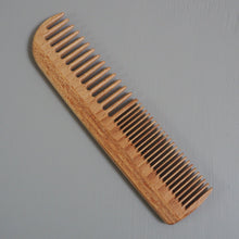 Load image into Gallery viewer, Wooden comb on a gray background
