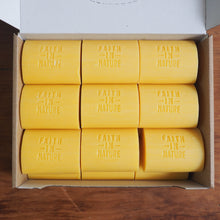 Load image into Gallery viewer, Box of yellow soap bars with 'Faith in Nature' branding on a wooden surface
