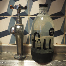 Load image into Gallery viewer, Glass wash up liquid bottle with silver tap and tiled background
