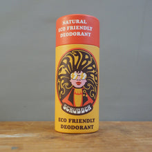 Load image into Gallery viewer, A cylindrical can of Scrubber Eco Friendly Deodorant standing upright on a wooden surface against a plain gray wall.
