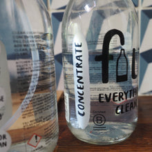 Load image into Gallery viewer, A clear glass bottle of floor cleaner with a white label reading 'CONCENTRATE' and large black text 'fu EVERYDAY CLEAN', shown on a wooden surface with a blue-and-white tiled background.
