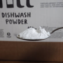 Load image into Gallery viewer, Spoonful of dishwash powder on a wooden surface with a box in the background
