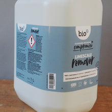 Load image into Gallery viewer, A large white plastic jug of bio compacts Lavandand laundry detergent with a light blue label, sitting on a wooden surface against a gray paneled wall.

