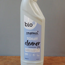 Load image into Gallery viewer, A bottle of bio compact toilet cleaner standing on a wooden surface against a plain gray wall.
