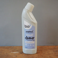 Load image into Gallery viewer, A bottle of bio compostable toilet cleaner, positioned on a wooden surface against a plain gray wall.
