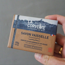 Load image into Gallery viewer, La Corvette dish soap bar held in hand against grey background
