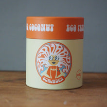 Load image into Gallery viewer, A cylindrical container of Schubbach Coconut Egg Curry paste, featuring a cream-colored body with a retro circular logo and an orange lid, set on a wooden surface against a gray background.

