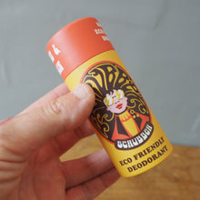Load image into Gallery viewer, Eco friendly deodorant in cardboard tube in hand against an grey and brown backgrouind
