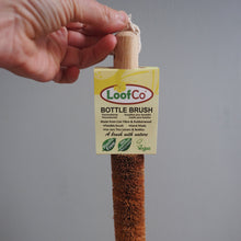Load image into Gallery viewer, Bottle brush with a LoofCo label held by a hand against a gray background
