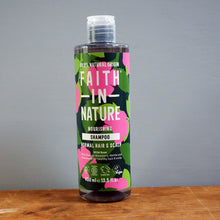 Load image into Gallery viewer, Bottle of Faith in Nature shampoo on a wooden surface with a gray background
